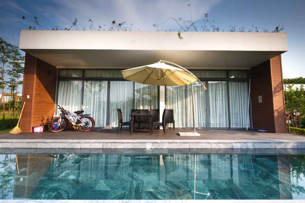 bikes near chairs and cantilever parasol